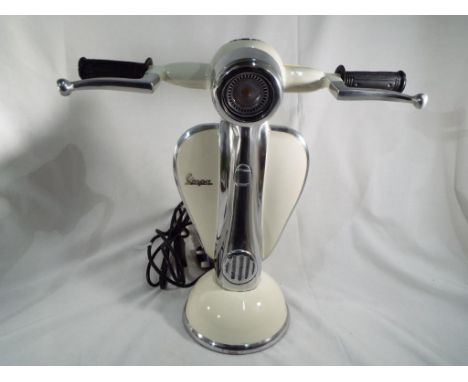 An unusual table lamp in the form of a Vespa scooter, approximate height 41 cm (h). Estimate £80 - £120