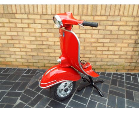 An unusual standard lamp in the form of half of a full size Vespa scooter with working headlight approx 108cm (h)