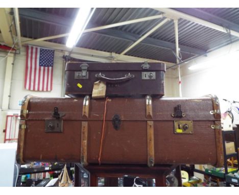 A vintage travelling trunk and a vintage suitcase
