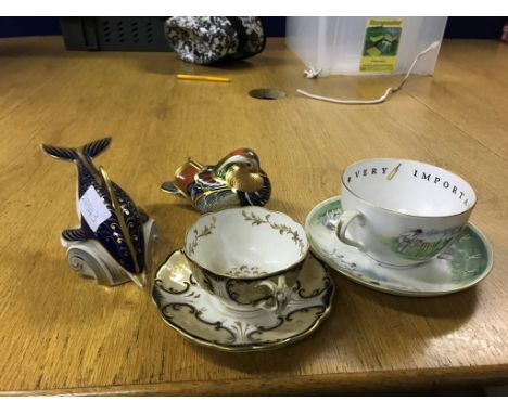A Royal Crown Derby dolphin; together with a Royal Crown Derby bird, a Royal Worcester cricket cup and saucer and a 19th cent