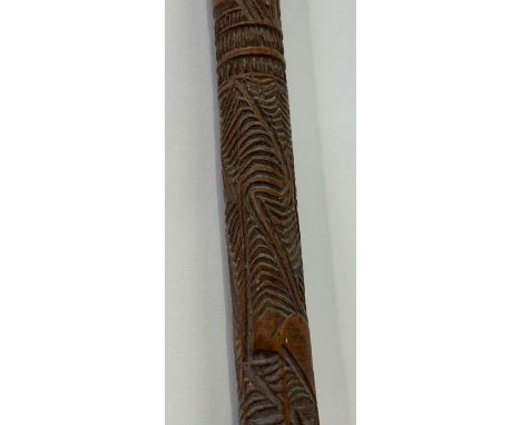 A Maori wooden stick, probably 20th century, shaped and carved throughout with typical bands of dentil decoration in relief, 