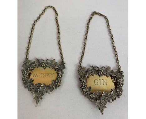 A pair of silver wine labels, by J Figg &amp; Son Ltd, London 1972, the cast fruiting vine border enclosing a silver gilt tic