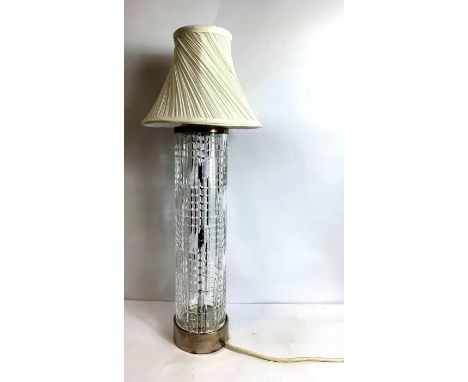 An Art Deco tall cut glass table lamp base, with linear and diamond shaped decoration, chromed base and rim, with later shade