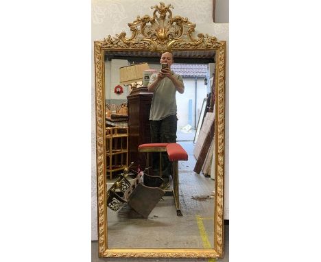 A 20th century gilt framed mirror, with painted highlights and decorative finial, 151cm x 75cm 