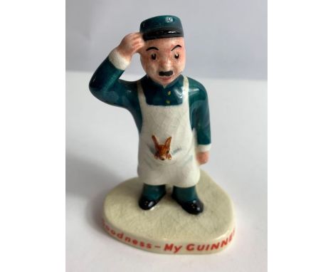 A Carltonware Guinness ceramic advertising figure of a zookeeper with a roo in his apron, applied red marks to the base, 10cm