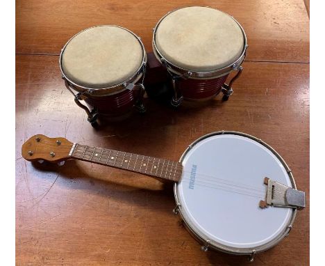 A vintage ukelele, along with a set of bongo drums 