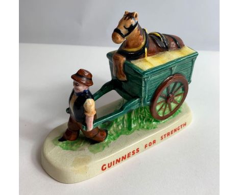 A ceramic Carltonware Guinness advertising figure of a man pulling his cart and horse, applied red marks to the base and stam
