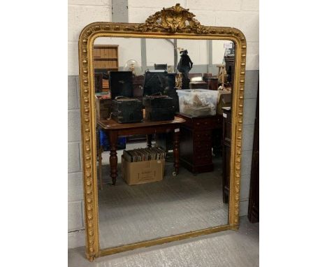 A 19th century gilt framed mirror, with repeated border pattern with a central flower motif finial, 124cm wide,177cm high
