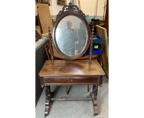 A 19th century rosewood dressing table, with oval swing mirror with a carved finial of a bird with acorns, single long drawer