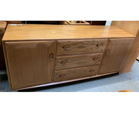 An Ercol beech and elm sideboard, with three central drawers, flanked by two cupboard sections, 68cm high, 154cm long, 43cm d