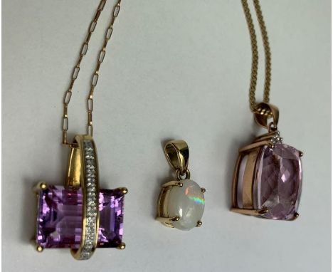 An amethyst and diamond pendant on a chain; with another pendant on a chain; and an opal pendant