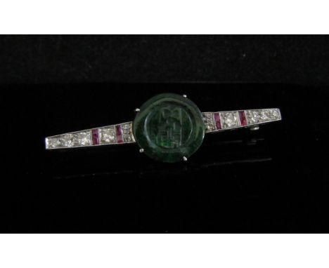 An Art Deco style ruby and diamond bar brooch with a central jade roundel, unmarked, 4.5cm long, 4g