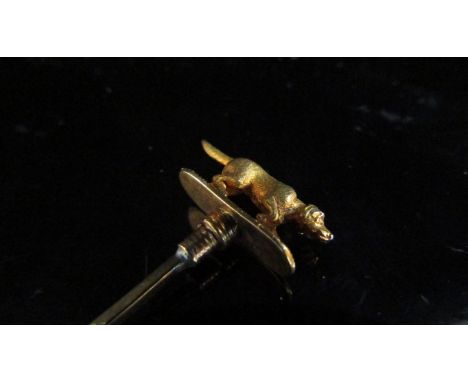 A stick pin surmounted by a gundog, unmarked, 2.1g
