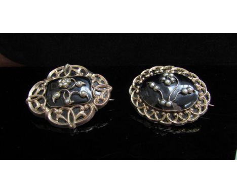 Two Victorian gold, black enamelled mourning brooches with seed pearl set flower motifs, woven hair panel backs inscribed G.R