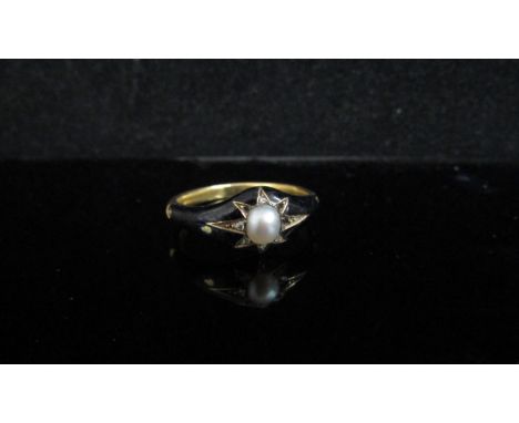 A gold black enamel mourning ring with single pearl and old cut diamond chips, inscribed "In memory of The Rev Charles Martyn