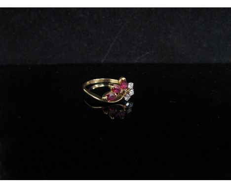 An 18ct gold diamond and ruby ring. Size L/M, 2g