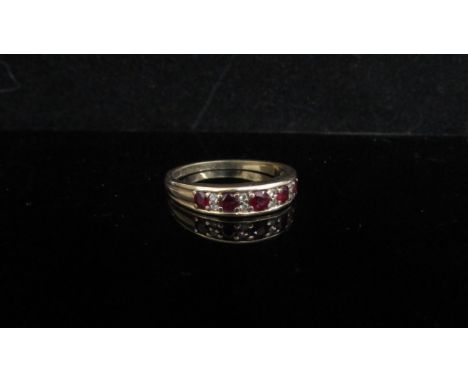 A 9ct gold ruby and diamond half hoop ring. Size S, 2.7g