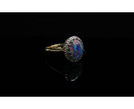 A black opal and diamond ring, stamped 18ct. Size R, 3.4g