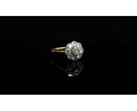 A gold diamond daisy ring, stamped 18ct/plat. Size R, 2.7g