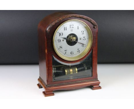 Early 20th century Bulle mahogany cased electric mantel clock, the silvered dial set with Arabic numerals, raised on four bra