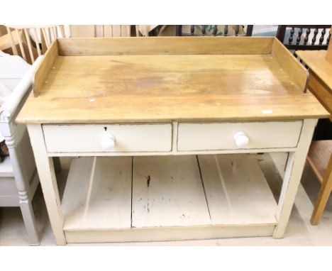 A vintage substantial painted kitchen work table with two drawers and pot shelf beneath. 