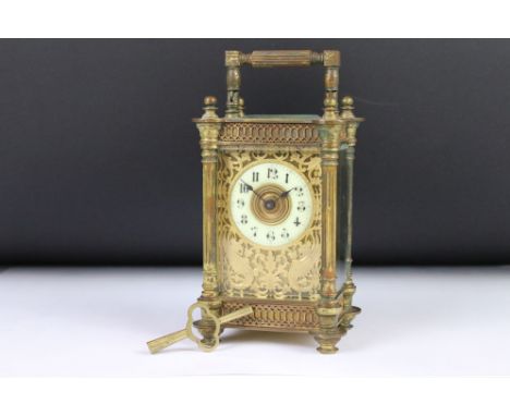 An antique French made carriage clock, brass cased with bevelled glass panels, decoratively detailed front panel, maker marke