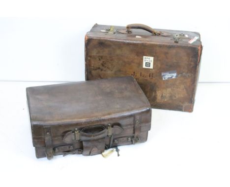 Two vintage brown leather suitcases. 