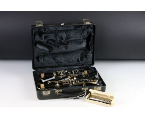 A Selmer Company Bundy cased clarinet together with a Hohner harmonica. 