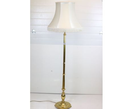 20th century Brass Corinthian Column Standard Lamp raised on a circular base with four feet, with shade, 157cm high to top of