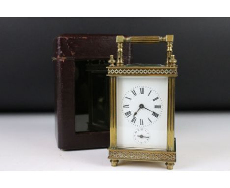 An antique French made carriage clock, brass cased with bevelled glass panels, white enamel dial with subsidy second dial, co