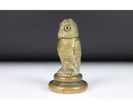 A cast metal table top inkwell in the form of an owl with glass eyes and flip top lid. 