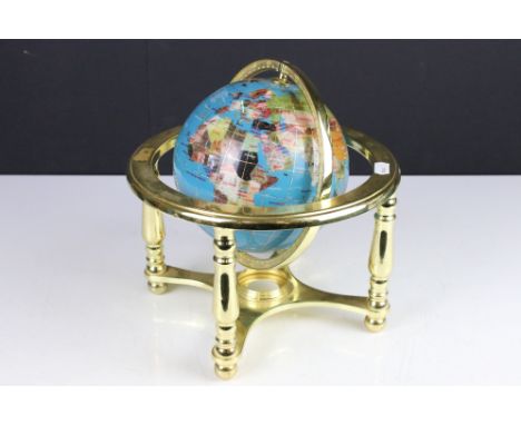 A contemporary desktop globe made with semi precious stones and mounted on brass framework. 