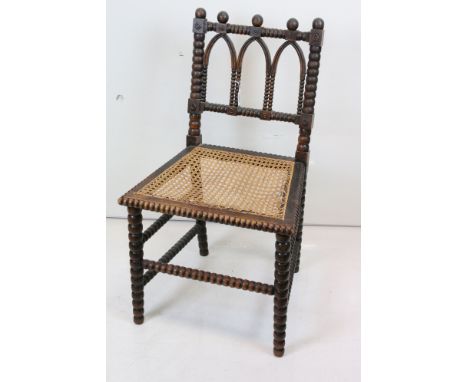 19th century Gothic Revival Side Chair with carved bobbin supports and cane seat (seat a/f), 49cm wide x 85cm high 