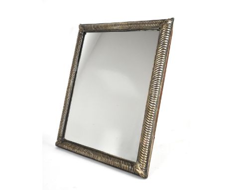 A William and Mary silver toilet mirror, circa 1691, maker's mark partially rubbed, the rectangular plate with gadrooned bord