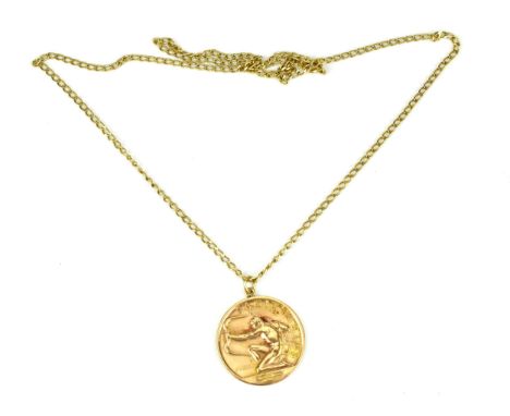A 9ct yellow gold zodiac Sagittarius sign pendant on chain by Paul Vincze, the circular pendant with relief arrow-shooting fi