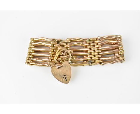 A 9ct yellow gold gate link bracelet, with textured brick links, heart shaped clasp and safety chain, weight 28.8 grams 