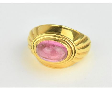 A Boucheron 18ct yellow gold and tourmaline dress ring, the pink cabochon stone centred in a stepped oval mount, hallmarked 7