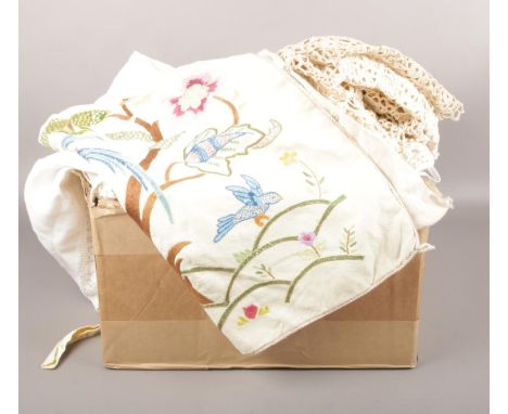 A box of mixed linens, table cloths, doilies, cushion covers with tapestry detailing etc  