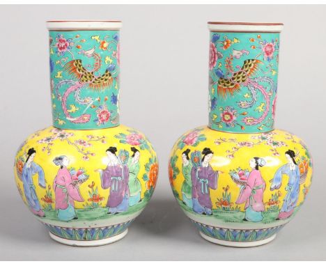 A pair of early 20th century Japanese porcelain mantel vases, each decorated with figures and trailing prunus blossom over ye