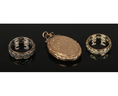 Two vintage eternity rings and a 9ct gold back and front locket.  