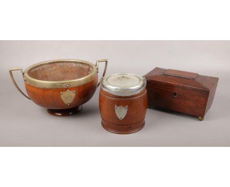 A Victorian mahogany tea caddy, along with an oak biscuit barrel and an oak twin handle presentation bowl.  