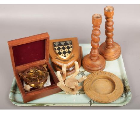 A tray of mainly wooden items including butter dish, pair of candlesticks, college plaques and a cased reproduction brass sun