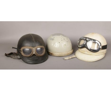 Three vintage motorcycle pudding basin helmets including Lycett, Geno and Aviakit. Two with goggles.  