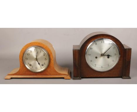 A carved oak Enfield mantle clock, along with a Garrard Clocks Ltd mantle clock, both with silvered dials, chiming on coiled 