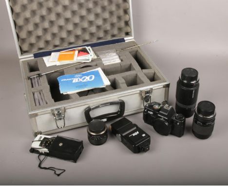 A cased Praktica Bx20 35mm camera, along with three lenses, flash etc.  