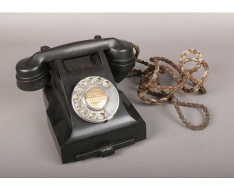 A vintage rotary dial telephone.  
