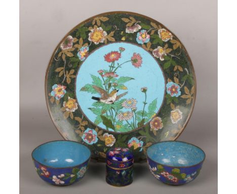 A Japanese Meiji period cloisonne dish decorated with a bird, two similar small bowls and a champleve enamel pot and cover.  