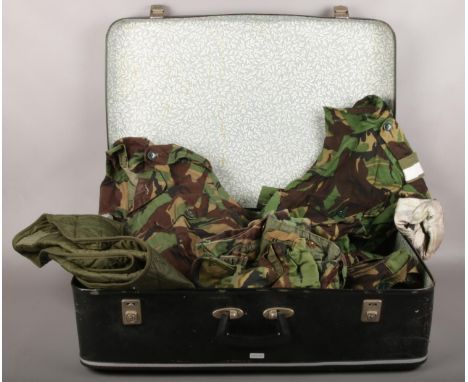 A vintage suitcase containing army combat clothing, two combat trousers size 01, 80, two Smock jackets chest 88/ size 01 , Li