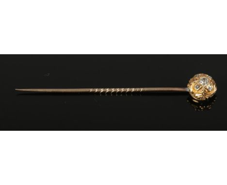 A Victorian gold stick pin set with 5 rose cut diamonds.  