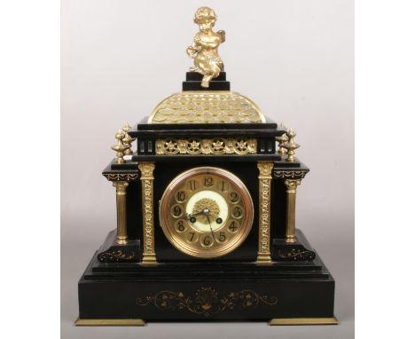 A Victorian slate and gilt metal mantel clock. Surmounted by a bacchanalian putti, with Classical pilasters and brass chapter